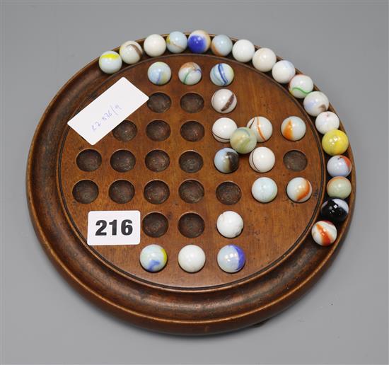 A solitaire board and marbles